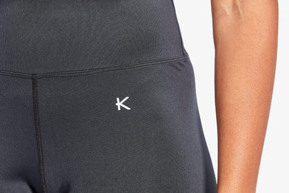Black athletic outfit with a logo on a plain background