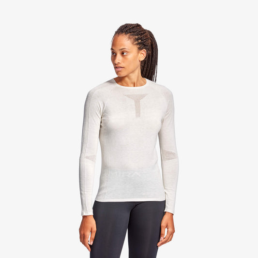 Woman wearing a white long-sleeve athletic shirt on a white background