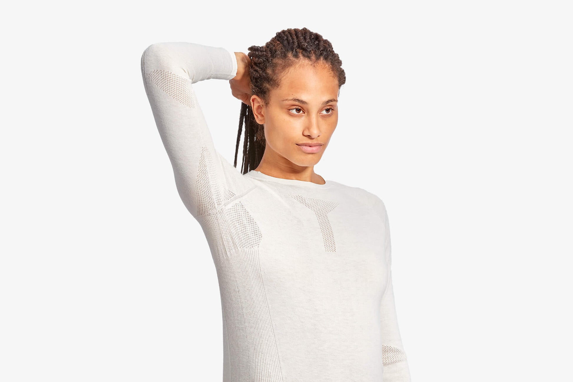 Woman wearing a white long-sleeve shirt against a white background