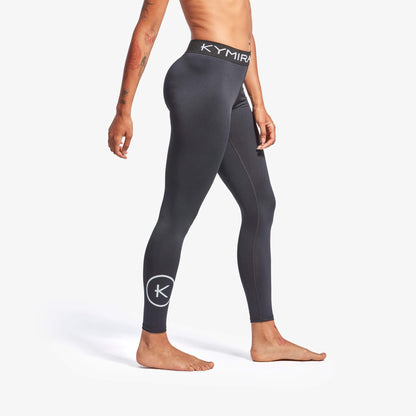 Person wearing black leggings with Kymira logo on a white background