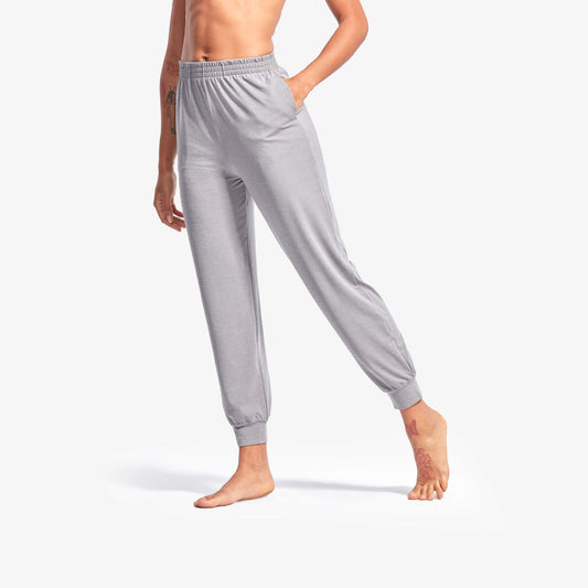 Person wearing gray sweatpants on a white background