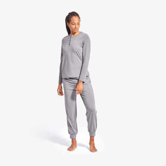 Woman wearing a gray loungewear set on a white background