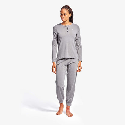 Woman wearing gray pajama set on a white background