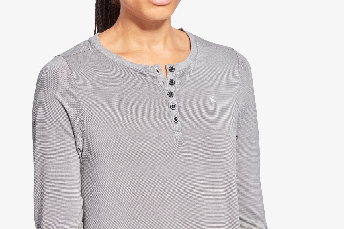 Gray long-sleeve henley shirt worn by a person on a white background