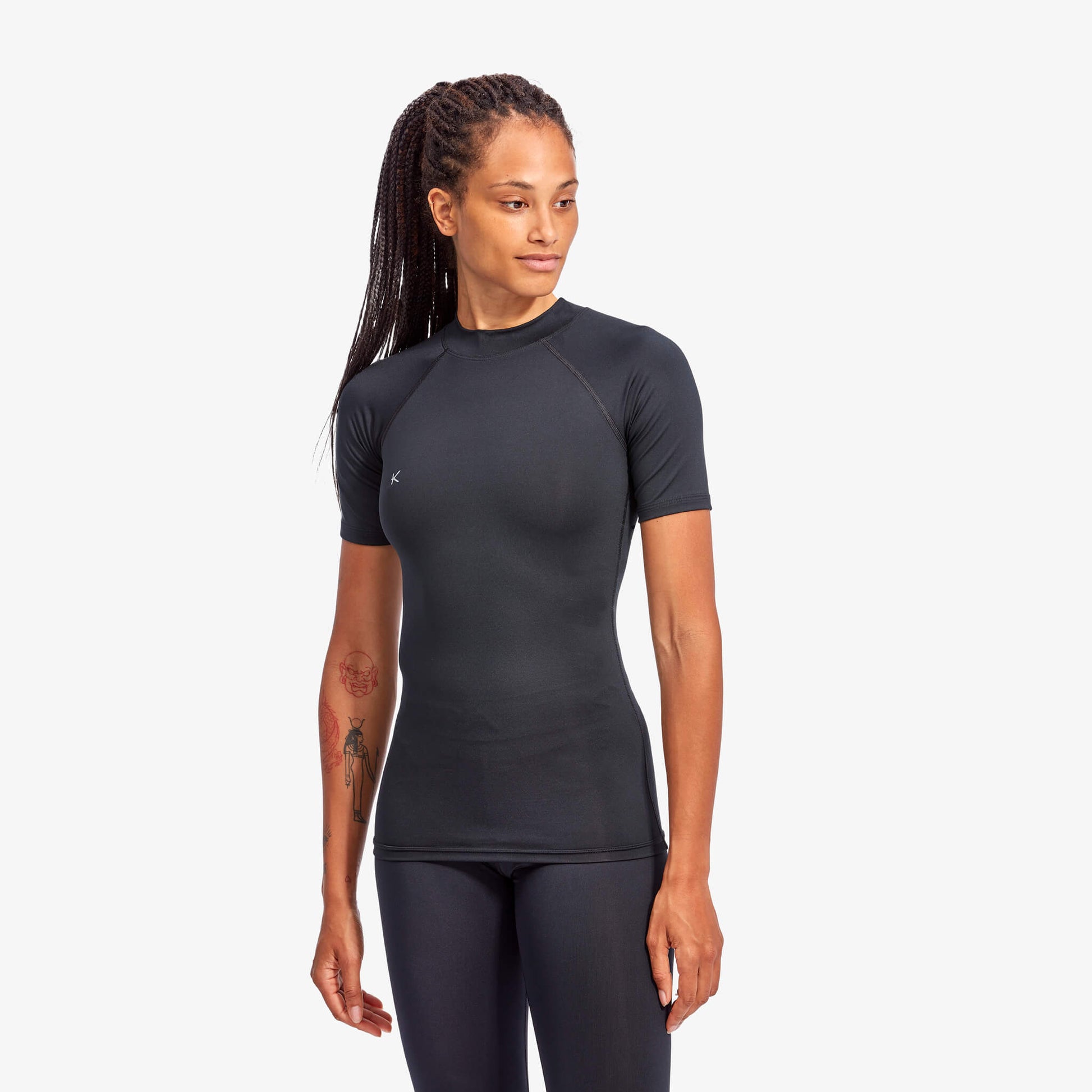 Woman wearing a black athletic outfit on a white background