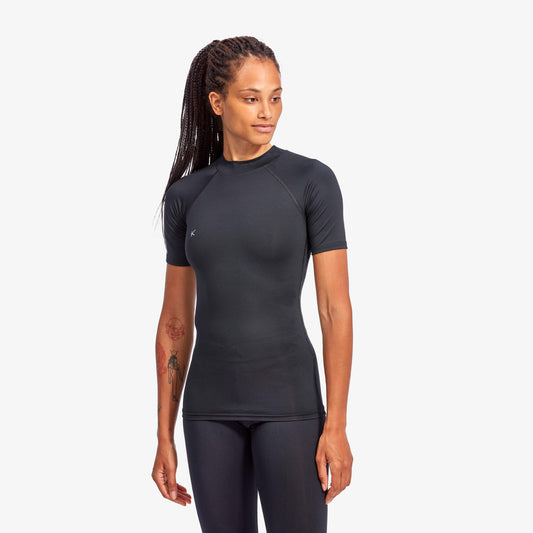 Woman wearing a black athletic outfit on a white background