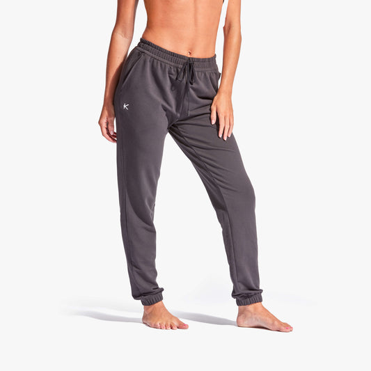 Person wearing gray sweatpants on a white background