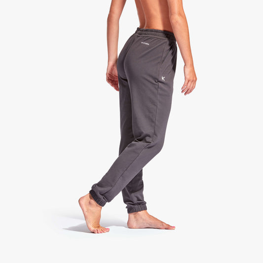 Person wearing gray sweatpants on a white background