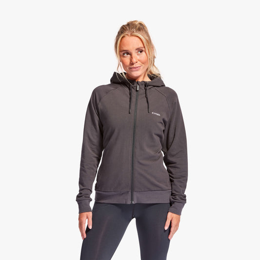 Woman wearing a gray hoodie with a brand logo on a white background