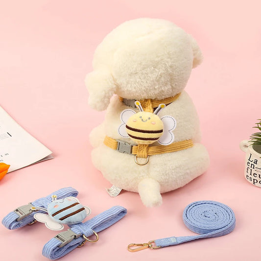 Plush toy sheep with a bee-themed harness and leash on a pink background