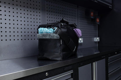 Black bag with colorful contents on a metal shelf