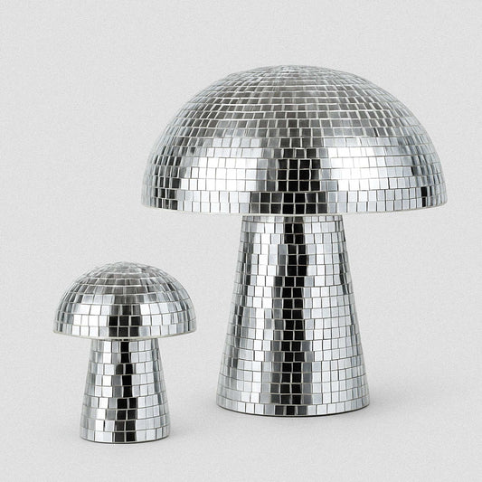 Two silver disco mushroom lamps on a light gray background