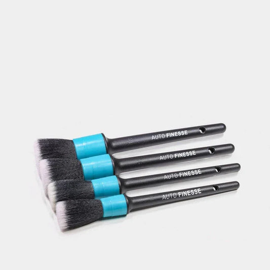 Set of detailing brushes with blue handles and black ferrules on a white background