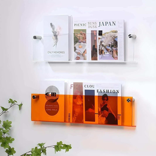 Wall-mounted magazine rack with books and magazines on a white wall.