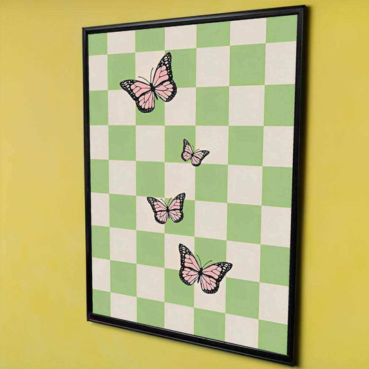 Framed artwork with a green and white checkered pattern and pink butterflies on a yellow wall.