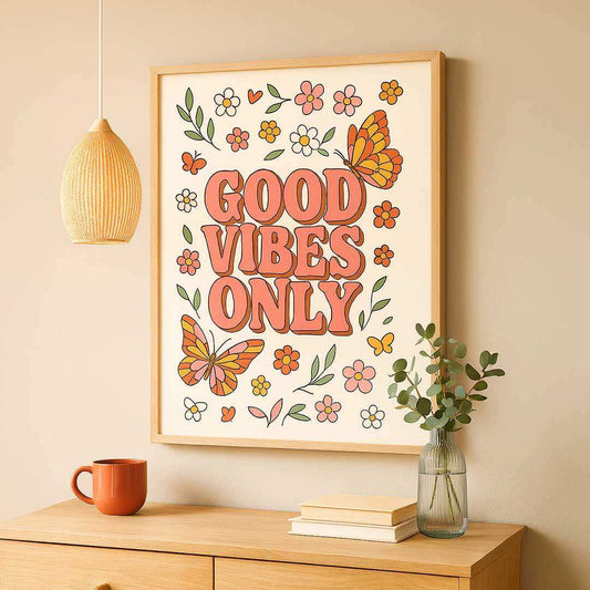 Framed artwork with 'Good Vibes Only' text on a wall above a wooden shelf.