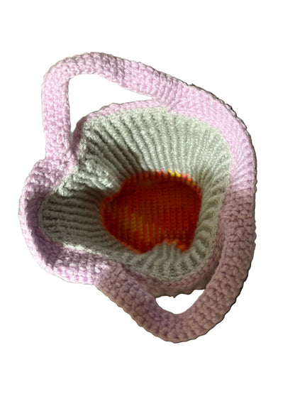 Handmade crochet mini tote bag in lilac wool, top-down view showing open