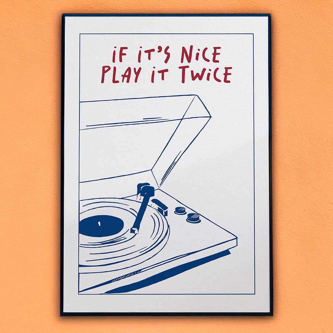 Framed poster with a record player illustration and text 'If it's nice play it twice' on an orange background