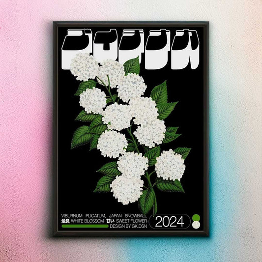 Framed artwork of white flowers with green leaves on a black background, featuring text and a year.