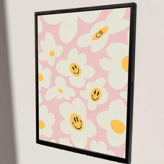 Framed artwork with smiley face flowers on a pink background