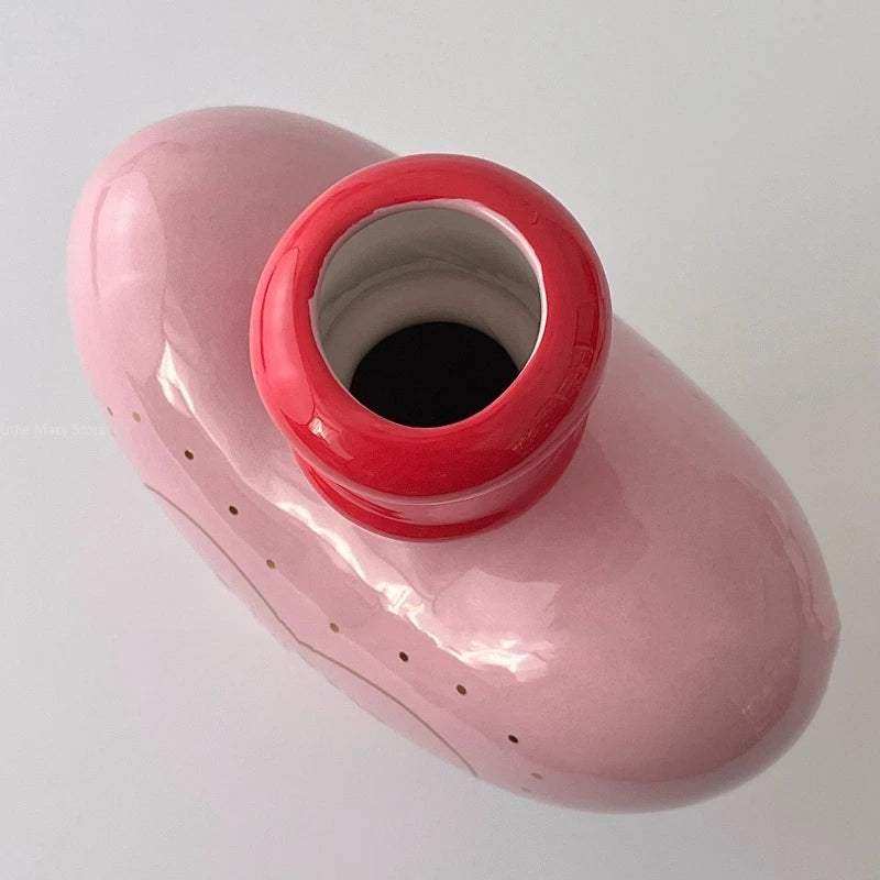 Pink and red plastic container on a white background