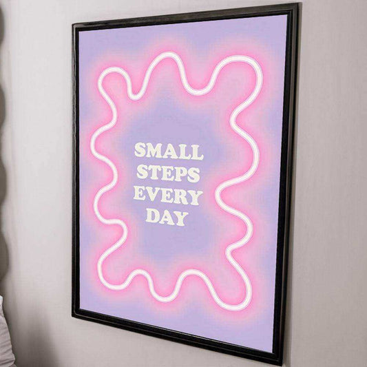 Framed artwork with pink neon outline and 'Small Steps Every Day' text on a pastel background.
