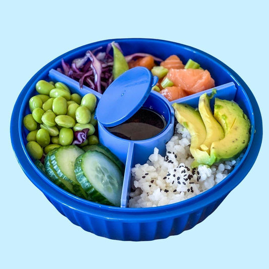 Blue bento box with compartments filled with various food items on a light blue background