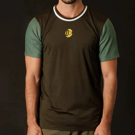 Person wearing a brown and green t-shirt with a logo on a black background