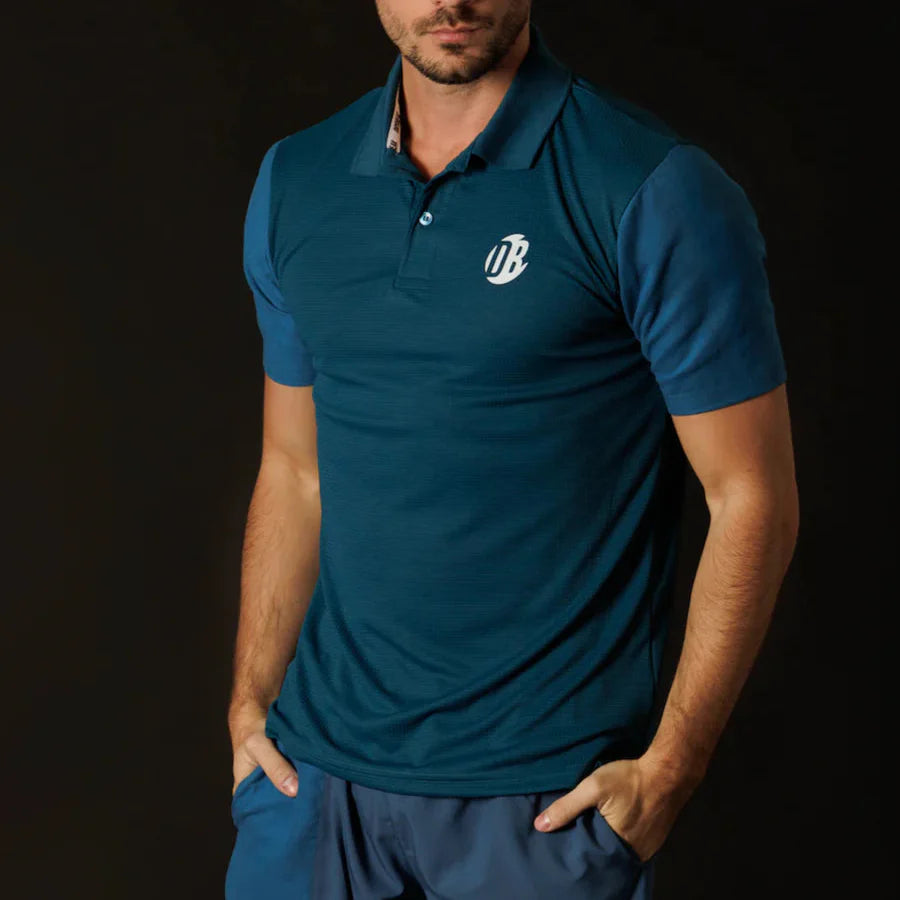 Man wearing a blue polo shirt with a logo on a black background