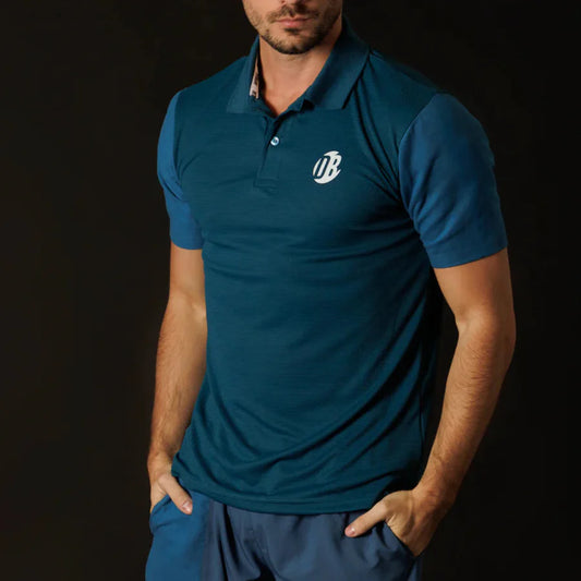 Man wearing a blue polo shirt with a logo on a black background