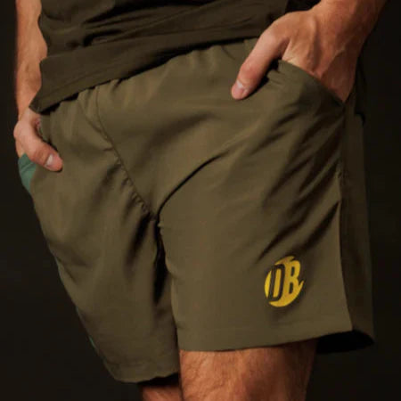 Green shorts with a yellow logo on a dark background