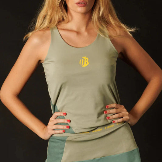 Woman wearing a green tank top with a logo on a black background