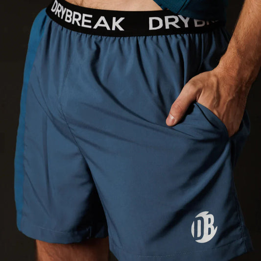 Blue athletic shorts with a visible brand logo on a dark background