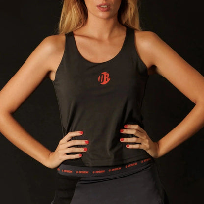 Woman wearing a black tank top with a red logo on a black background