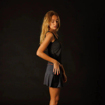 Woman wearing a black dress against a dark background