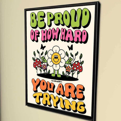 Motivational poster with colorful text and cartoon flowers on a beige wall.