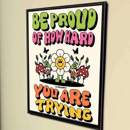 Motivational poster with colorful text and cartoon flowers on a beige wall.