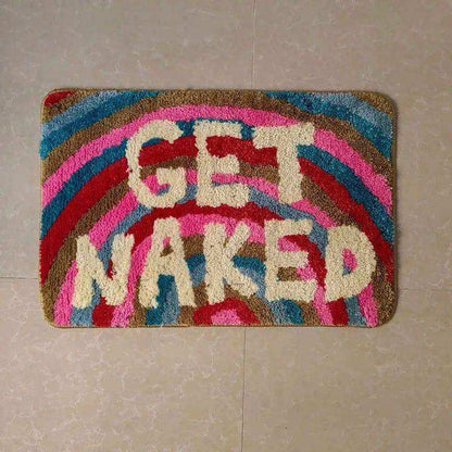 Colorful doormat with 'GET NAKED' text on a tiled floor.