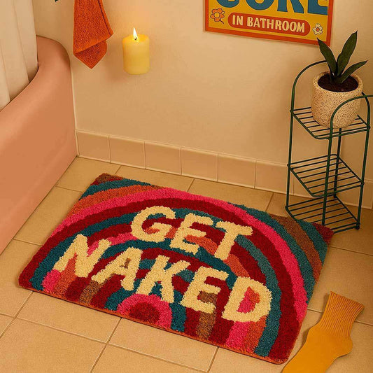 Colorful bath mat with 'GET NAKED' text in a bathroom setting.
