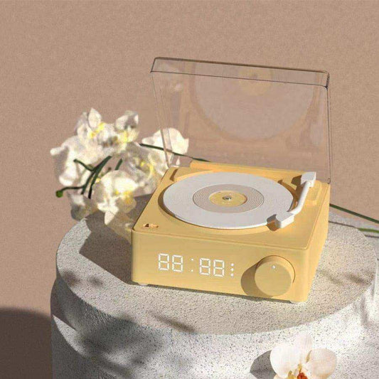 Yellow record player with digital display on a round surface with flowers