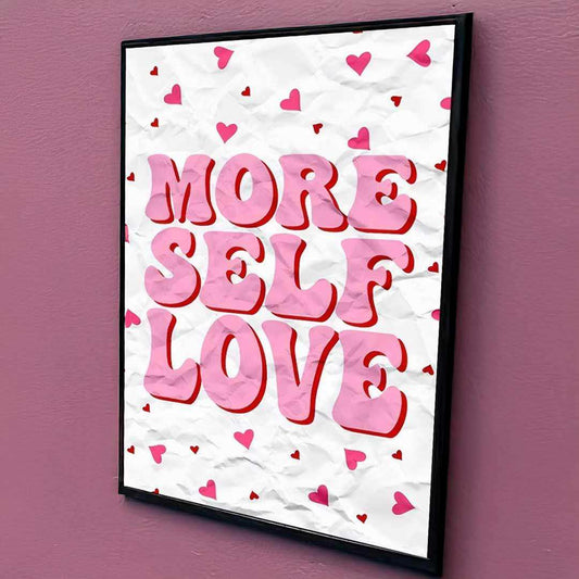 Framed poster with 'More Self Love' text on a white background with pink hearts, against a purple wall.