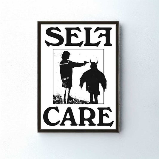 Framed artwork with silhouette of a person and a dog, and the word 'SELF CARE'.