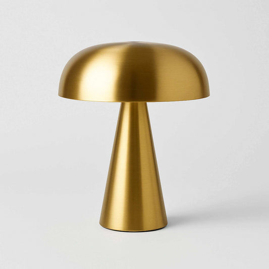 Gold table lamp with a white background