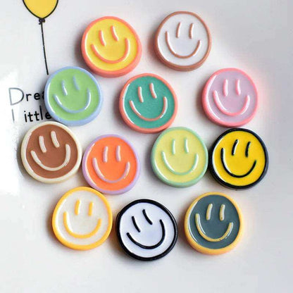 Colorful smiley face fridge magnets on a white background