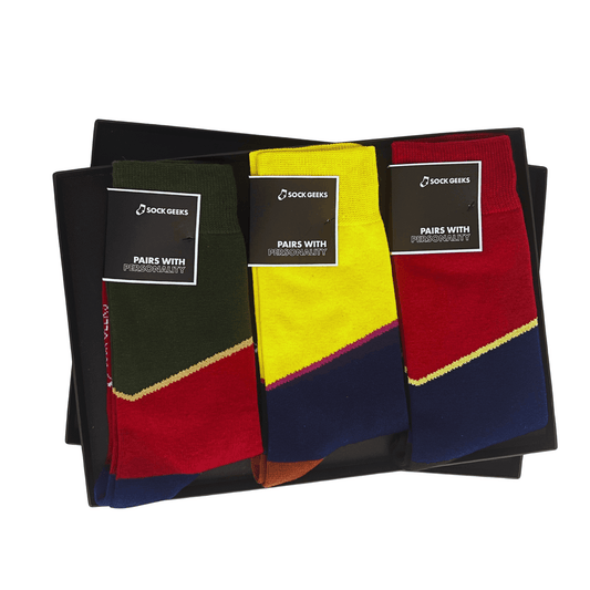 Three pairs of socks in black, yellow, and red with matching packaging on a white background.