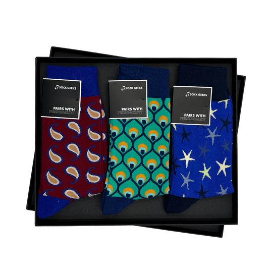 Three pairs of patterned socks in a black box with 'Sock Geeks' labels.