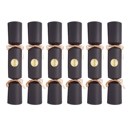 Row of black Christmas crackers with gold centers on a white background