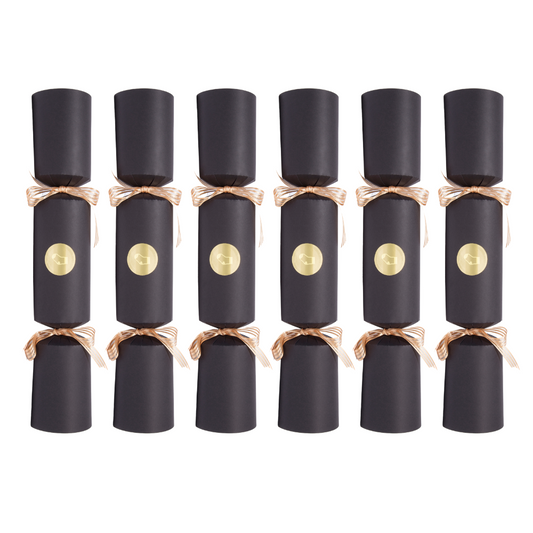 Row of black Christmas crackers with gold centers on a white background
