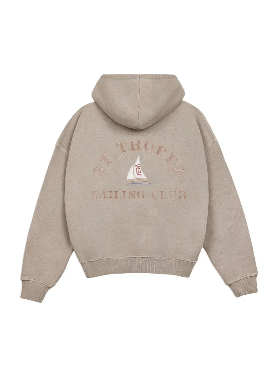 Beige hoodie with 'St. Tropez Sailing Club' text and logo on the back against a white background