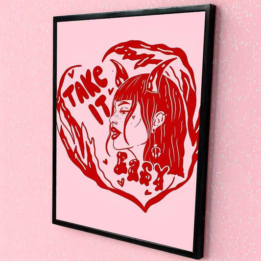 Framed artwork with a red illustration of a woman and text on a pink background